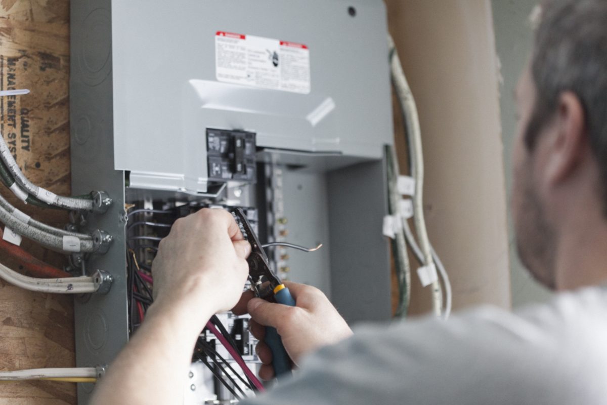 Electrician working on a consumer unit and wiring